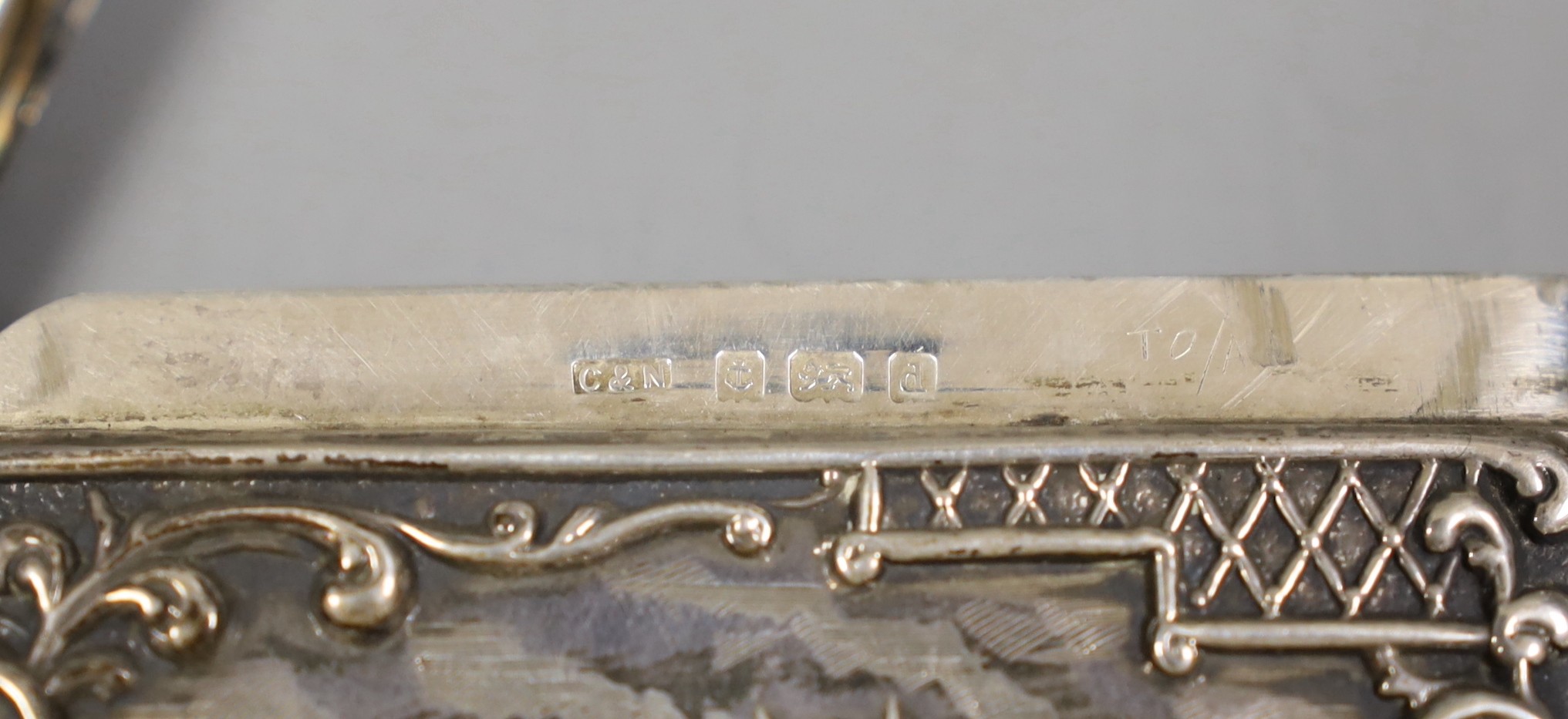 An Edwardian embossed silver card case, decorate d with stag in highland scene, Crisford & Norris, Birmingham 1903, 10.1cm.